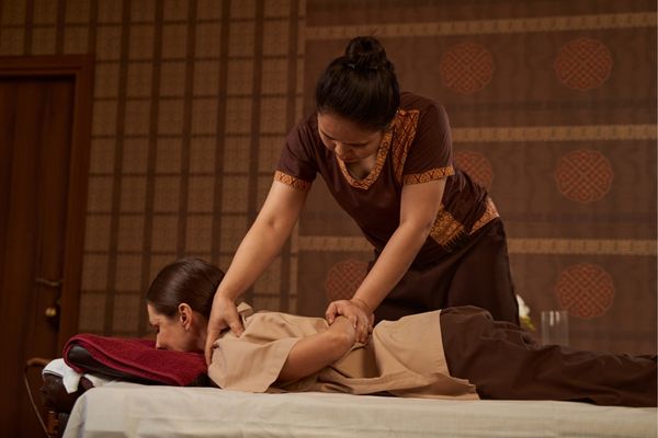 Client receiving a traditional Thai massage.